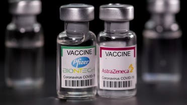 FILE PHOTO: Vials with Pfizer-BioNTech and AstraZeneca coronavirus disease (COVID-19) vaccine labels are seen in this illustration picture taken March 19, 2021. REUTERS/Dado Ruvic/Illustration/File Photo