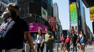 People wear masks around Times Square, as cases of the infectious coronavirus Delta variant continue to rise in New York City, July 23, 2021. (Reuters)