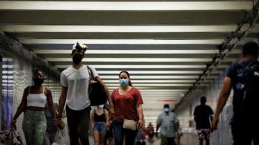 People wear masks as they pass through a pedestrian subway as cases of the infectious coronavirus Delta variant continue to rise in New York City, New York, US, on July 26, 2021. (Reuters)