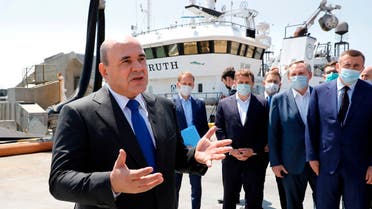 Russian Prime Minister Mikhail Mishustin visits the Gidrostroi's fish processing plant, on the disputed Pacific islands claimed by Japan, known by the Russians as the Kuril Islands and the Japanese as the Northern Territories, on July 26, 2021.  (AP)