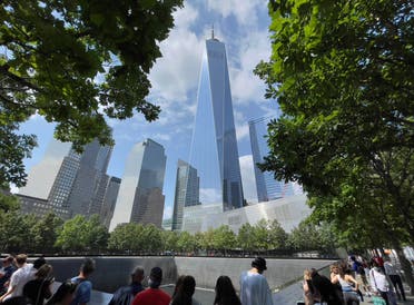 One World Trade Center building is seen as people visit the 9/11 memorial in New York on July 18, 2021. (AFP)
