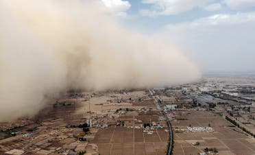 This aerial photo taken on April 25, 2021 shows a sandstorm engulfing a village in Linze county, in the city of Zhangye in China's northwestern Gansu province. (AFP)
