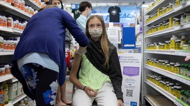 Abby Oplinger, 13, receives the Pfizer-BioNTech coronavirus disease (COVID-19) vaccine after Pennsylvania authorized the vaccine for those over 12-years-old at Skippack Pharmacy in Schwenksville, Pennsylvania, US, May 12, 2021. (Reuters)