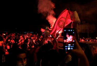Supporters of Tunisia's President Kais Saied gather on the streets as they celebrate after he dismissed the government and froze parliament, in Tunis, Tunisia July 25, 2021. (Reuters)