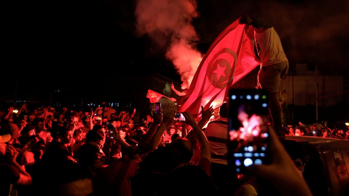 Supporters of Tunisia's President Kais Saied gather on the streets as they celebrate after he dismissed the government and froze parliament, in Tunis, Tunisia July 25, 2021. (Reuters)
