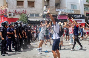  Protesters face Tunisian police officers during a demonstration in Tunis, Tunisia, Sunday, July 25, 2021. (AP)