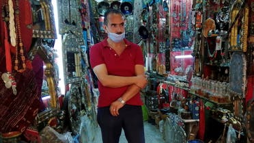 Abdesattar Massoudi, the owner of an artisanal store, attends an interview with Reuters inside his shop in the tourist bazaar in the Old City of Tunis, Tunisia July 27, 2021. (Reuters)