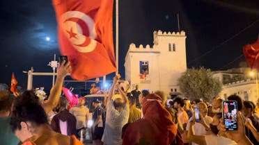 Crowds gather on the street after Tunisia's president suspended parliament, in La Marsa, near Tunis, Tunisia July 26, 2021, in this still image obtained from a social media video. (Reuters)