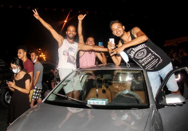  Demonstrators celebrate from the car during a rally after the president suspended the legislature and fired the prime minister in Tunis, Tunisia, Sunday, July 25, 2021. (AP)
