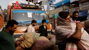 Workers load sacks of spices onto a truck at a wholesale market after authorities eased lockdown restrictions that were imposed to slow the spread of the coronavirus disease (COVID-19), in the old quarters of Delhi, India, June 8, 2021. (Reuters)