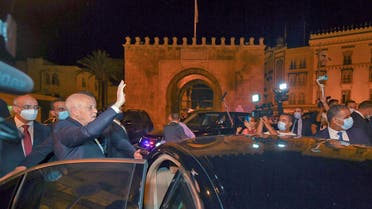 A handout picture provided by the Tunisian Presidency Facebook Page on July 26, 2021 shows Tunisian President Kais Saied gesturing as he enters a vehicle in Tunis's central Habib Bourguiba Avenue, after he ousted the prime minister and ordered parliament closed for 30 days. (AFP)