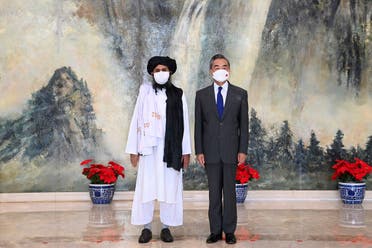 Taliban co-founder Mullah Abdul Ghani Baradar, left, and Chinese Foreign Minister Wang Yi pose for a photo during their meeting in Tianjin, China, on July 28, 2021. (AP)