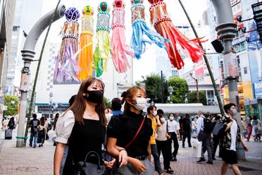 People walk in Shibuya area of Tokyo, Japan, on July 29, 2021. (Reuters)