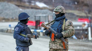 An Azeri soldier and police officer talk as they stand guard at the Kalbajar district, Azerbaijan, December 21, 2020. (File photo: Reuters)