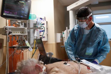 A critical care respiratory therapist works with a coronavirus disease positive patient in the intensive care unit (ICU) at Sarasota Memorial Hospital in Sarasota, Florida. (File Photo: Reuters)