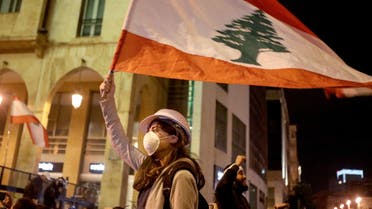 Lebanese protestors wave flags and shout anti-corruption slogans outside the parliament during a protest in Beirut on Jan. 21, 2020. (Reuters)