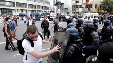 A protestor pushes on the shield of a police officer during a demonstration in Paris, France, on July 31, 2021. (AP)