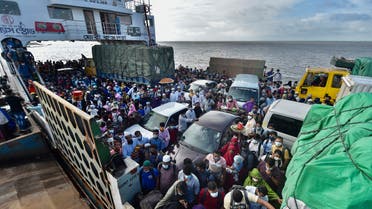 People wait to disembark from a ferry in Sreenagar on July 31, 2021 after they return to their work areas post the Bangladesh government relaxed the lockdown norms for all export oriented factories which were earlier imposed to curb the spread of COVID-19 coronavirus. (AFP)