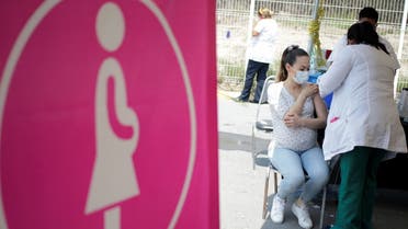 A pregnant woman receives a dose of Sinovac's CoronaVac coronavirus disease (COVID-19) vaccine during a mass vaccination program in Apodaca, on the outskirts of Monterrey, Mexico May 25, 2021. (Reuters)