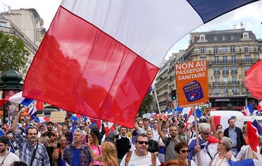 Protestors hold signs which read in French, “freedom” and “no to the vaccine passport” as they attend a demonstration in Paris, France, on July 31, 2021. (AP)