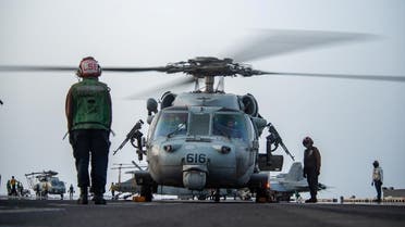 Sailors prepare an MH-60S Sea Hawk helicopter to launch on the flight deck of aircraft carrier USS Ronald Reagan (CVN 76), in response to a call for assistance from the Mercer Street. (Reuters)