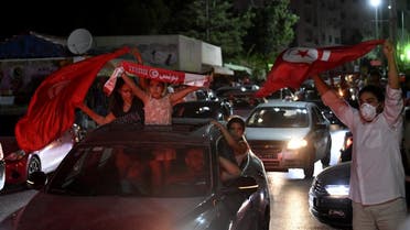 People celebrate in the streets of Tunis after Tunisian President Kais Saied announced the suspension of parliament and the dismissal of the PM, July 25, 2021. (AFP) 