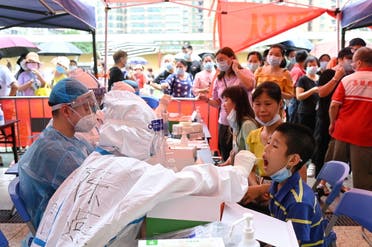 A medical worker collects a swab from a resident during a mass testing for the coronavirus disease (COVID-19) at a makeshift testing site at a stadium in Guangzhou, Guangdong province, China May 30, 2021. (File Photo: Reuters)