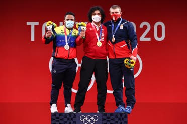 Gold medalist Fares Ibrahim Elbakh of Qatar, silver medalist Keydomar Vallenilla of Venezuela and bronze medalist Anton Pliesnoi of Georgia pose. (Reuters)