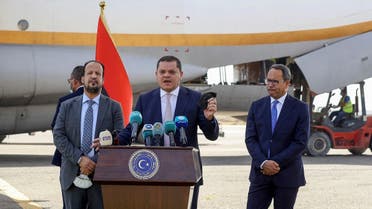 Libyan PM Abdulhamid Dbeibah (C) during a press conference after the arrival of over a million doses of the Chinese Sinopharm vaccine against COVID-19, at Mitiga International Airport in the capital Tripoli, on August 2, 2021. (Mahmud Turkia/AFP)