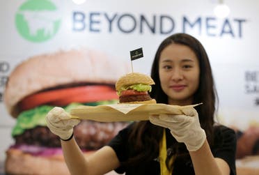 A staff member displays a burger with a Beyond Meat plant-based patty at VeggieWorld fair in Beijing, China November 8, 2019. Picture taken November 8, 2019. (File photo: Reuters)
