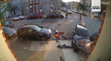 The moment a woman tried to run over a man during a heated argument in Baltimore, US. (Screengrab)