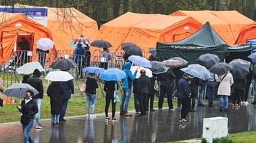 People queue in the rain at a mobile vaccination point against coronavirus disease (COVID-19) in Lodz, organised for the long weekend in several Polish cities, May 2, 2021. Tomasz Stanczak/Agencja Gazeta via REUTERS ATTENTION EDITORS - THIS IMAGE WAS PROVIDED BY A THIRD PARTY. POLAND OUT. NO COMMERCIAL OR EDITORIAL SALES IN POLAND.