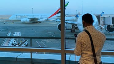 A passenger waits for his Emirates Airlines' flight departure to Dubai at Cairo's International Airport, Egypt July 20, 2021. (Reuters)