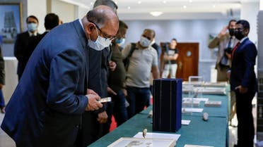 Officials look at artifacts seized by the US government and returned to Iraq, which are on display at the Ministry of Foreign Affairs in Baghdad, Iraq August 3,2021. (Reuters/Saba Kareem)