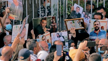 Relatives of victims of the August 4 blast carry pictures during a protest demanding accountability as the anniversary approaches of Lebanon's worst peace-time disaster, near the Justice Palace in Beirut on July 14, 2021.
