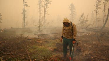 A specialist of the local forest protection service works to extinguish a forest fire near the village of Magaras in the region of Yakutia, Russia July 17, 2021. Picture taken July 17, 2021. (File Photo: Reuters)