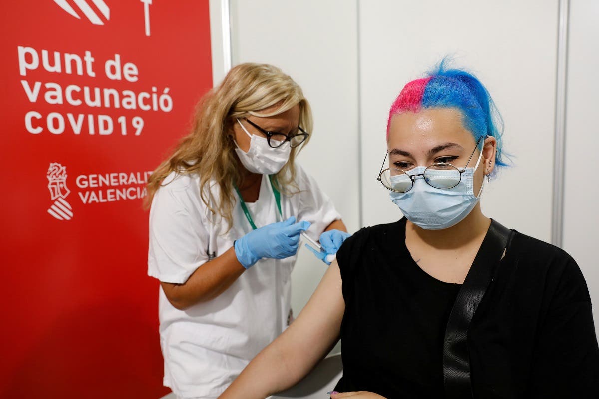 A woman receives a dose of Pfizer's BioNTech vaccine during the campaign against coronavirus disease (COVID-19) in the 20-29 age group at the City of Arts and Sciences vaccination centre in Valencia, Spain, on July 28, 2021. (Reuters)