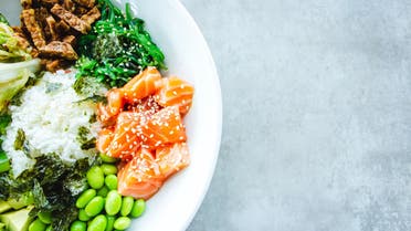 A salad bowl with edamame and raw salmon pieces is pictured. (Unsplash, Louis Hansel Restaurant Photographer)