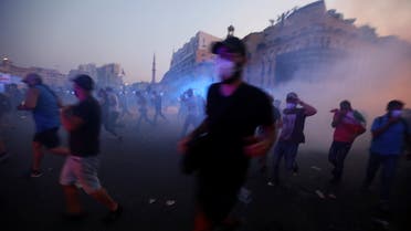 Demonstrators run during clashes with security forces during a protest near parliament, as Lebanon marks the one-year anniversary of the explosion in Beirut, Lebanon August 4, 2021. (Reuters)