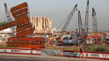 A justice symbol monument is seen near the grain silo damaged during last year's Beirut port blast. (File Photo: Reuters)
