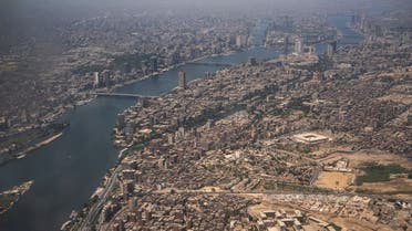 This picture taken on May 14, 2021 shows an aerial view of Egypt's capital Cairo, showing the historic old Cairo district (C) and the Nile river islands of (C to top) Manial al-Roda and Zamalek.