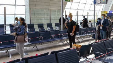 Passengers keep distance in a line at Dubai International Airport, as Emirates airline resumed limited outbound passenger flights amid the outbreak of the coronavirus in Dubai, UAE April 27, 2020. (Reuters)