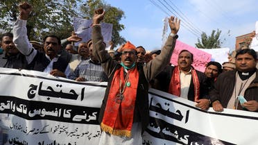 People carry banners as they chant slogans to condemn the attack on a century-old Hindu temple in northwestern Pakistan, during a protest in Peshawar, Pakistan, on January 3, 2021. (Reuters)