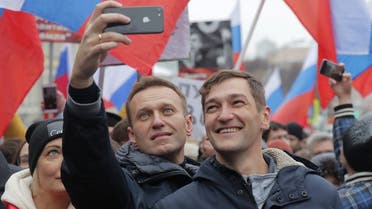Russian opposition leader Alexei Navalny (L) and his brother Oleg take selfie pictures during a rally in memory of politician Boris Nemtsov, who was assassinated in 2015, in Moscow, Russia, on February 24, 2019. (Reuters)