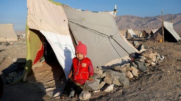 An internally displaced Afghan child sits outside a tent at a refugee camp in Herat province, Afghanistan. (File photo: Reuters)