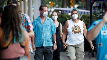 People wearing protective face masks walk in downtown St. Petersburg, amid coronavirus disease (COVID-19) pandemic, in Florida, US, August 6, 2021. (Reuters)