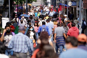 People walk along a crowded street at a commercial area as the coronavirus disease (COVID-19) outbreak continues in Mexico City, Mexico July 23, 2021. (Reuters)