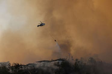 A helicopter tries to extinguish a wildfire near Marmaris, Turkey, August 3, 2021. (Reuters)