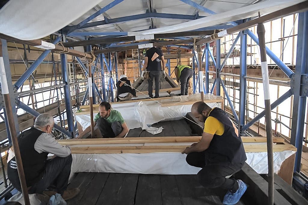 Technicians preparing the Solar Barque of Pharaoh Khufu (Cheops) as it is relocated from its old museum adjacent to the Great Pyramid to the nearby Grand Egyptian Museum. (AFP)
