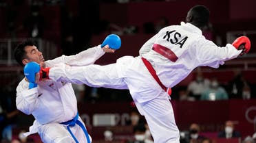  Sajad Ganjzadeh of Iran, left, is injured while competing against Tarek Hamedi of Saudi Arabia in their men's kumite +75kg gold medal bout for karate at the 2020 Summer Olympics, Saturday, Aug. 7, 2021, in Tokyo, Japan. (AP)